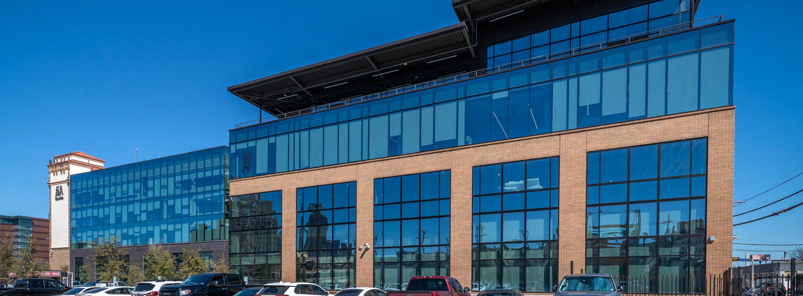 Daylight view of the Light Building’s glass-fronted addition and masonry facade.
